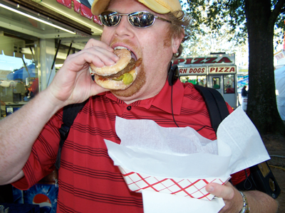 Andy eats a Krispy Kreme Burger at the Fair